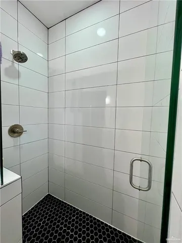 an empty room with wooden floor and a ceiling fan