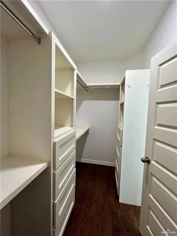 a bathroom with a granite countertop toilet and a sink