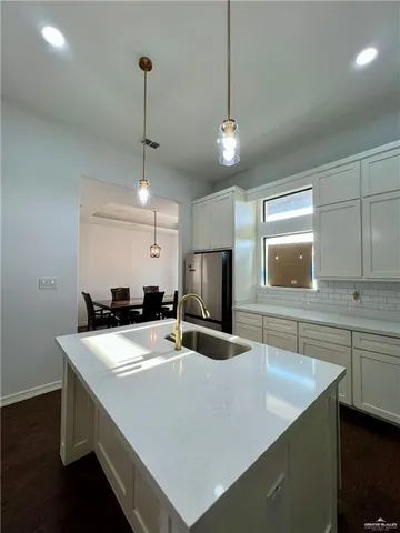 a kitchen with a stove a sink and a refrigerator