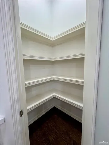 a view of a dining room with a table and chairs