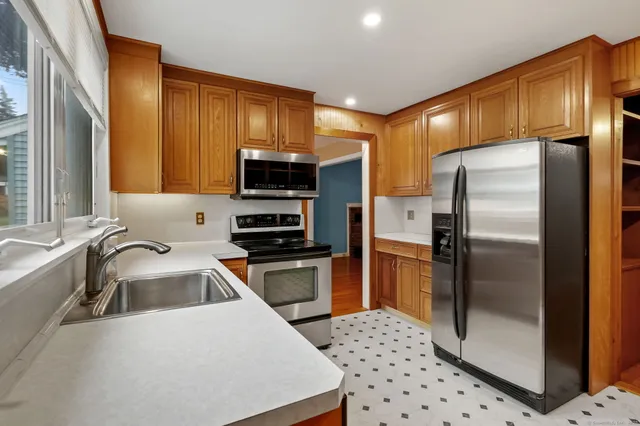 a kitchen with stainless steel appliances a refrigerator sink and microwave