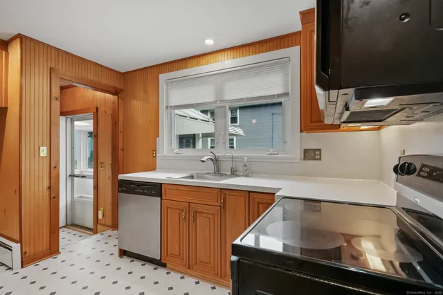 a kitchen with a sink appliances and cabinets