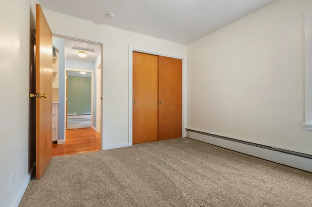 an empty room with closet and mirror