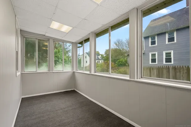 an empty room with closet and windows