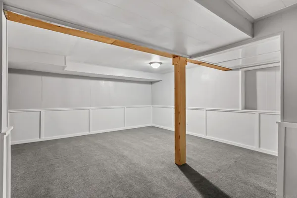 a view of an empty room with a fireplace and a window
