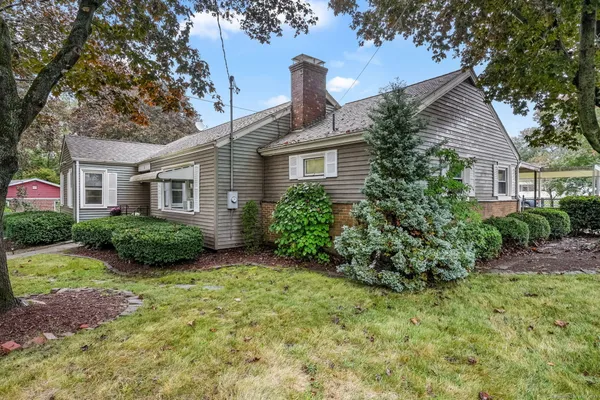 a view of a house with backyard and sitting area
