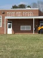 a view of a dry yard with wooden fence