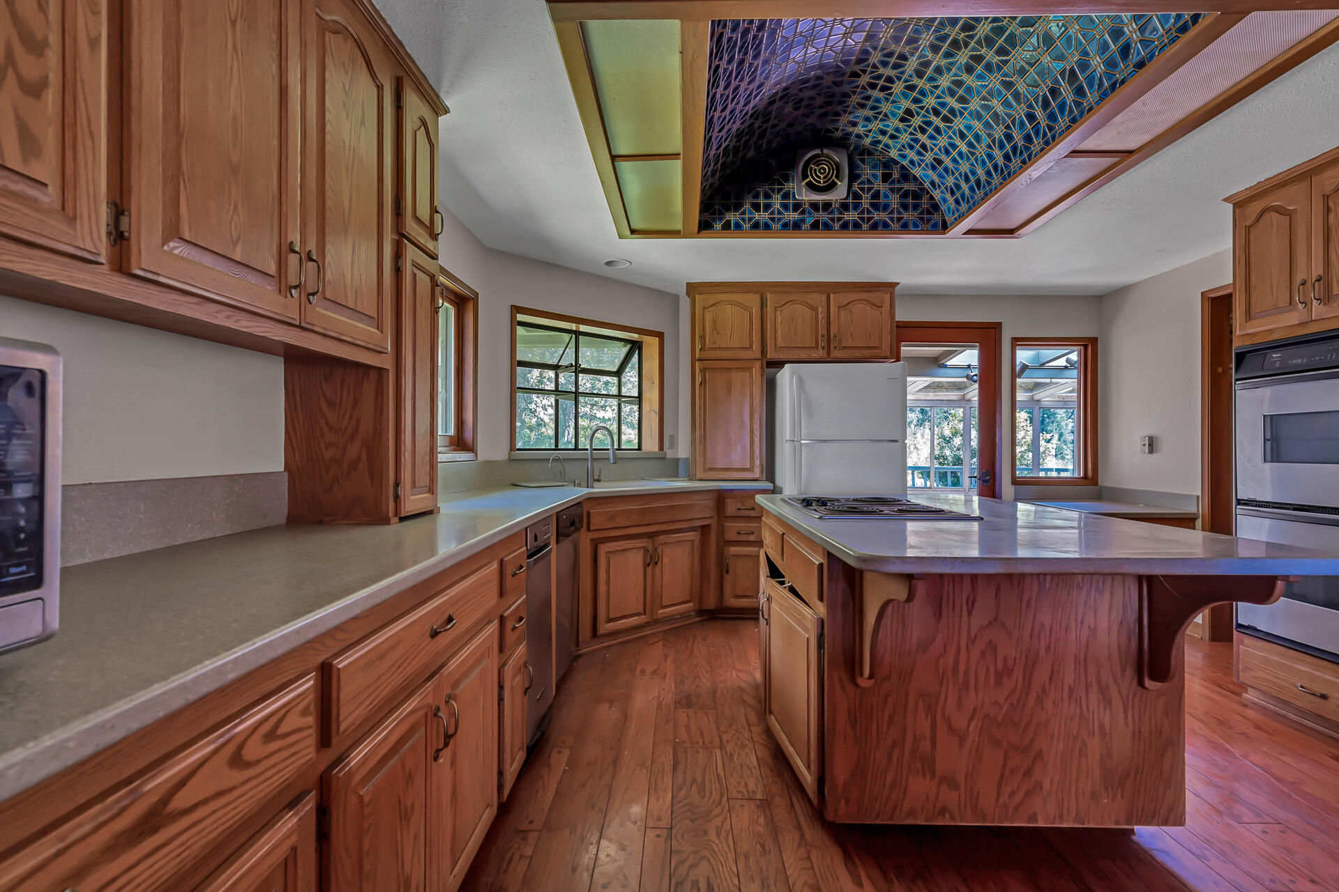15368 Star Flower Road Oak Run, CA 96069 - Photo 34 of 63 a kitchen with stainless steel appliances granite countertop a stove a sink dishwasher and cabinets with wooden floor