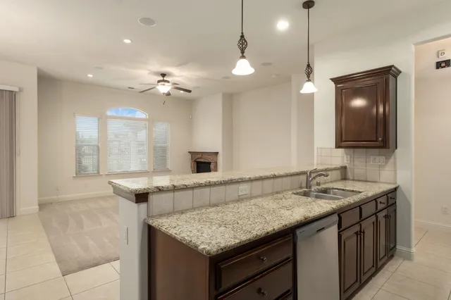 a bathroom with a granite countertop sink a large mirror and a shower