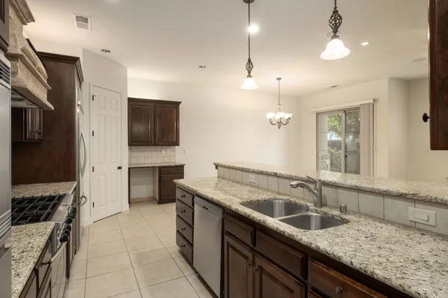 a kitchen with a sink stove and refrigerator