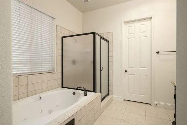 a bathroom with a bathtub and a shower