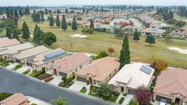 a sign board with building in the background