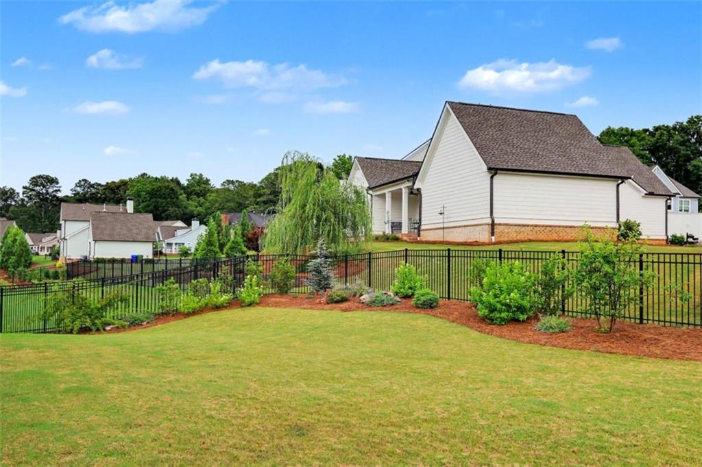 943 Clubside Drive Monroe, GA 30655 - Photo 90 of 93 a front view of a house with a yard and outdoor seating