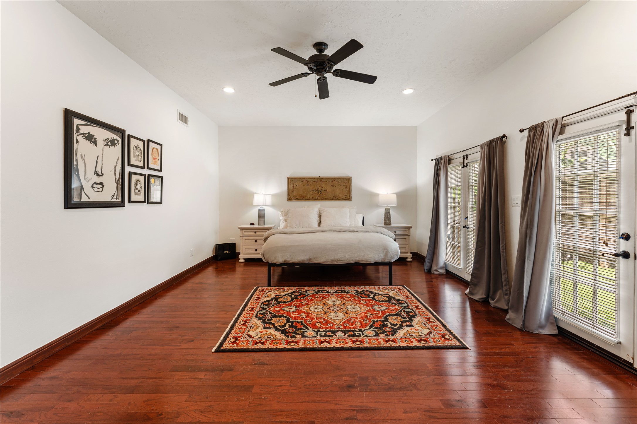 415 West 8th Street Houston, TX 77007 - Photo 7 of 39 Wake up to a spacious owner's retreat where oversized windows and elegant finishes create a bright, sophisticated ambiance. The generous layout easily accommodates a sitting area while maintaining an open, airy feel. Every detail has been thoughtfully curated to provide comfort with executive-level style.