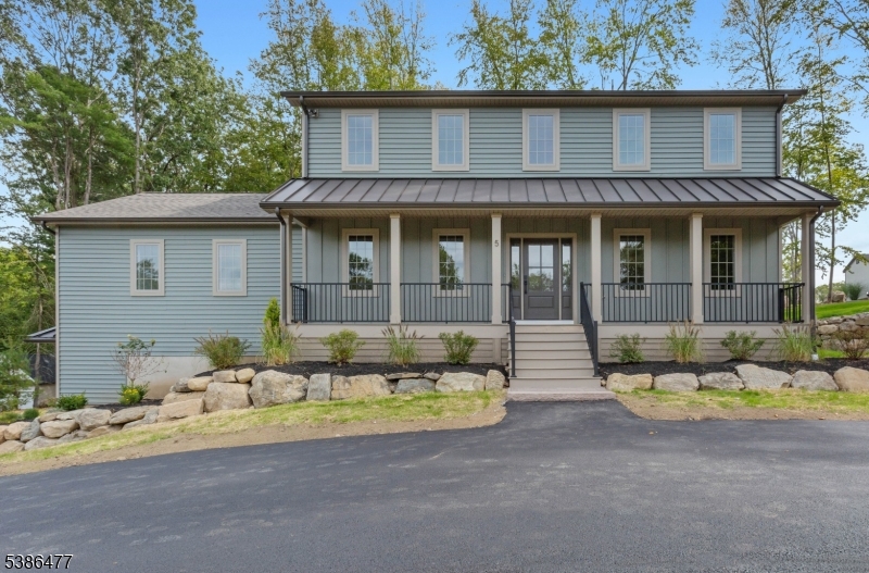 a front view of a house with a garden and patio