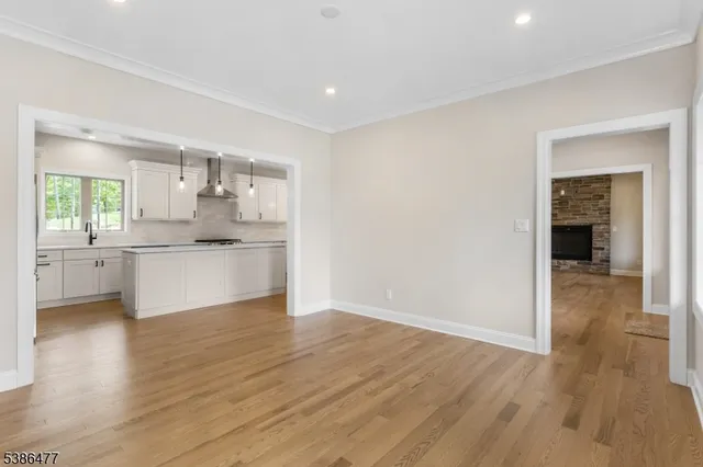 a view of a kitchen with wooden floor and a kitchen