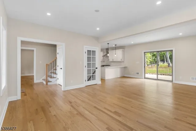 a view of a kitchen with wooden floor and a window