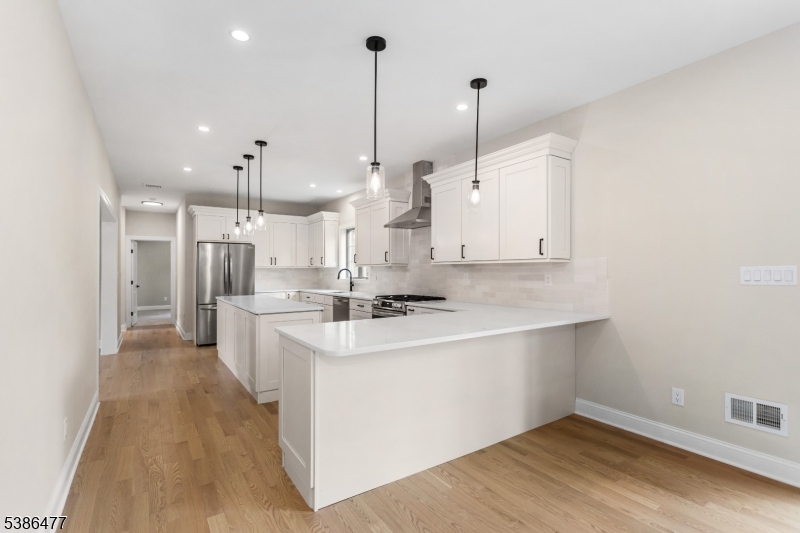 5 Percy Place Andover, NJ 07821 - Photo 20 of 50 a large kitchen with a large counter top a sink a stove and a wooden floors