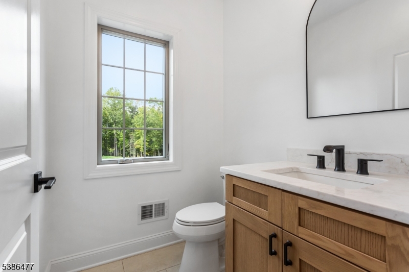 5 Percy Place Andover, NJ 07821 - Photo 21 of 50 a bathroom with a granite countertop sink toilet and mirror
