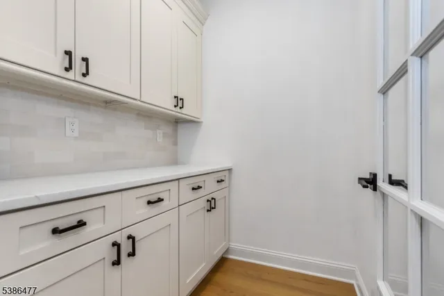 a view of a kitchen with white cabinets