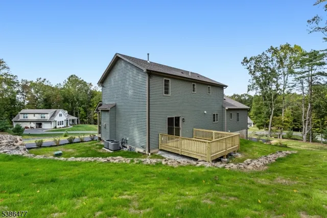 a view of a wooden deck next to a yard