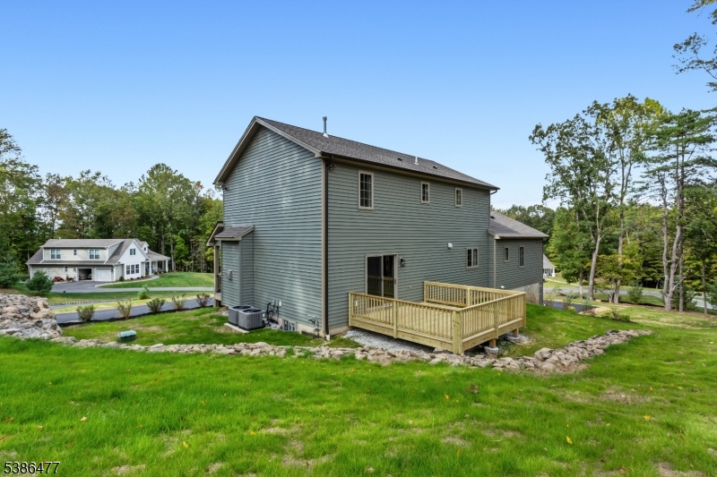5 Percy Place Andover, NJ 07821 - Photo 46 of 50 a front view of a house with a garden and trees