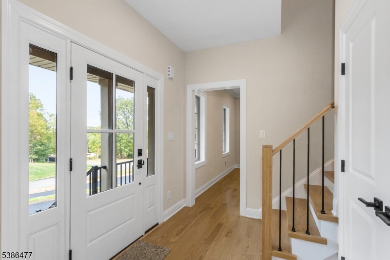 5 Percy Place Andover, NJ 07821 - Photo 6 of 50 a view of a hallway with wooden floor and staircase