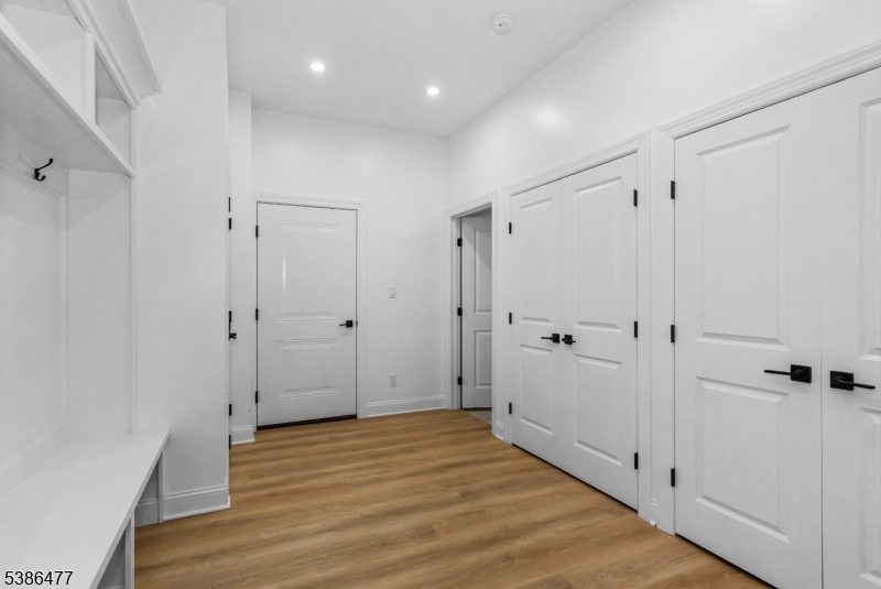 5 Percy Place Andover, NJ 07821 - Photo 9 of 50 a view of a hallway with wooden floor and closet area