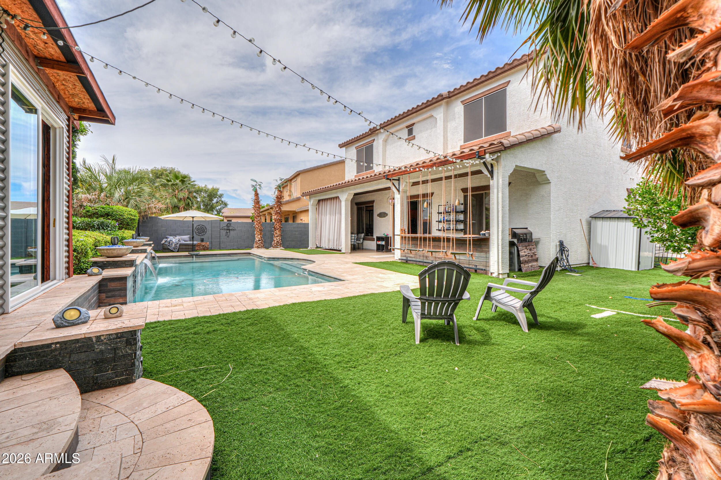 45247 West Jack Rabbit Trail Maricopa, AZ 85139 - Photo 64 of 75 a view of a house with a backyard patio and swimming pool
