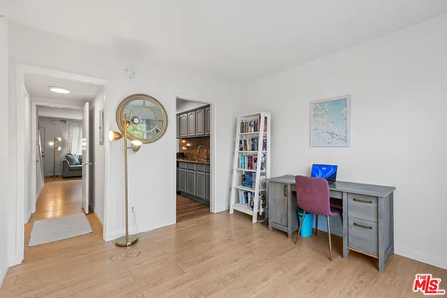 a view of a workspace with furniture and wooden floor