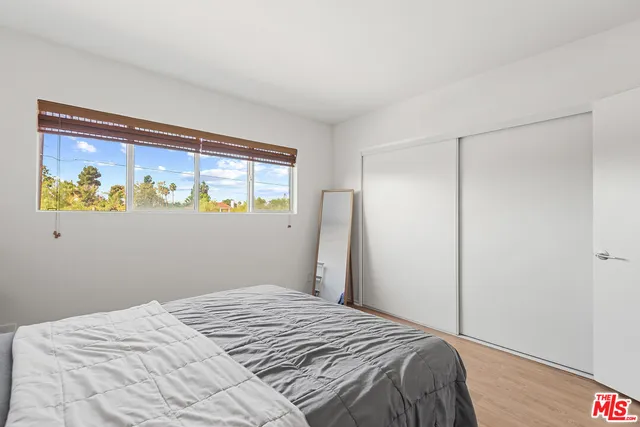 a bedroom with a bed and a window