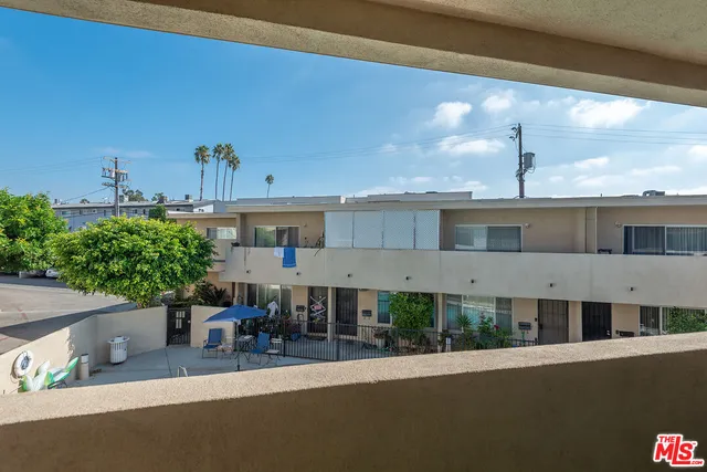 an aerial view of a house with a yard and potted plants