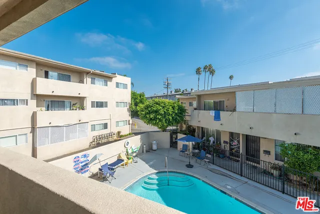 a view of a patio with table and chairs potted plants with wooden floor