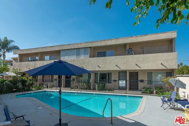 a view of a house with backyard patio and swimming pool