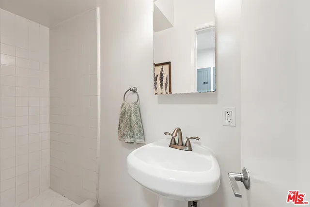 a bathroom with a sink and mirror