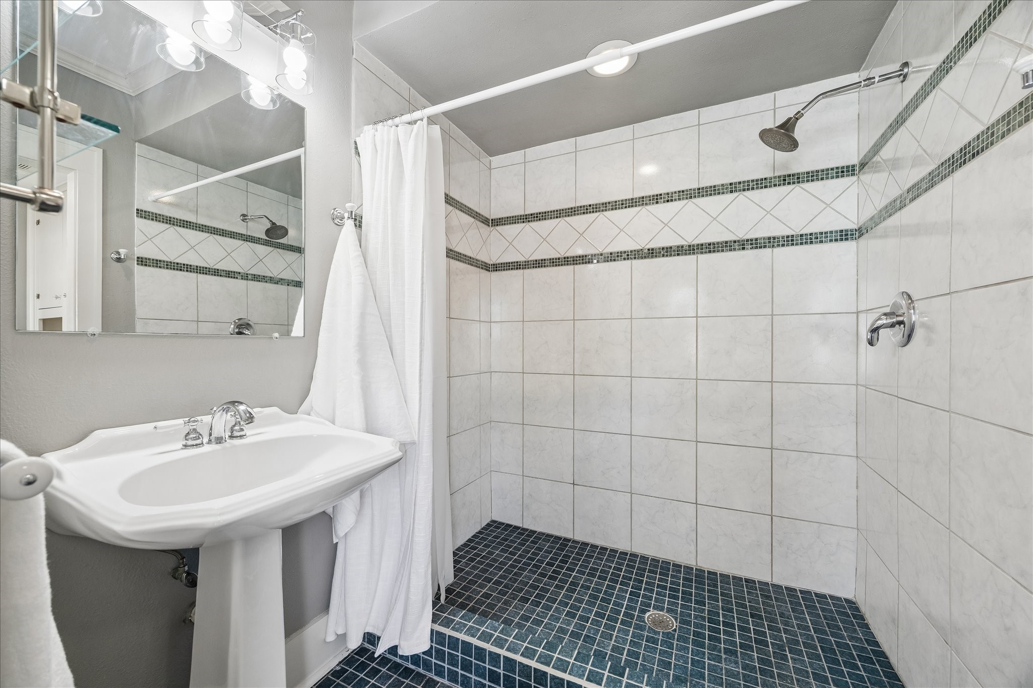 919 Key Street Houston, TX 77009 - Photo 20 of 39 Primary bath features a large walk-in shower with custom tile.