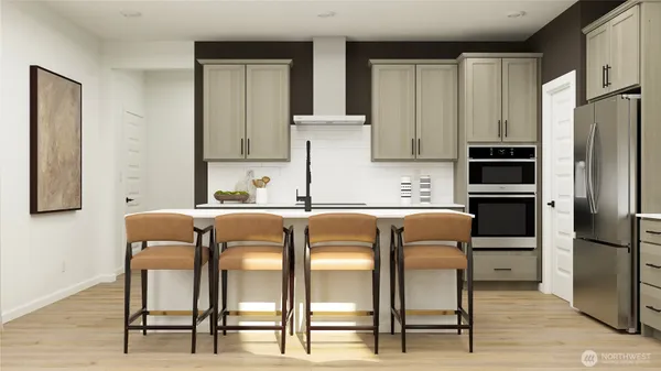 a kitchen with stainless steel appliances granite countertop a chairs and a refrigerator