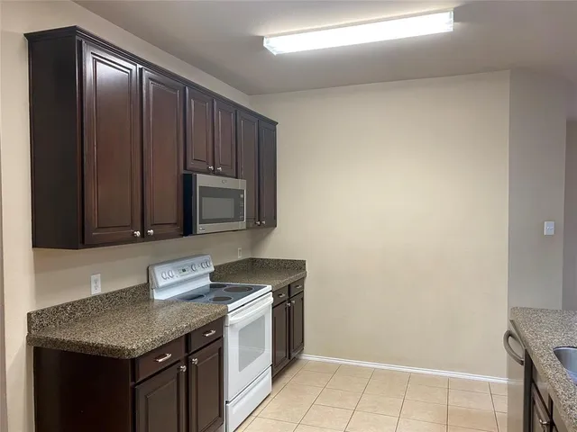 a kitchen with a stove and a microwave