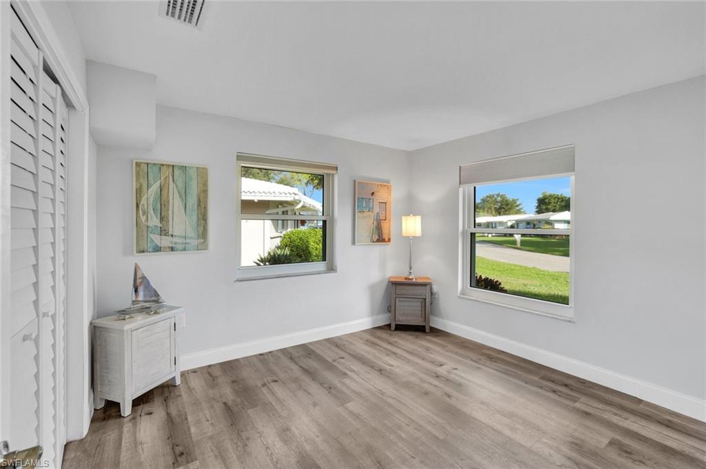 54 Hilo Court, Unit 54 Naples, FL 34112 - Photo 11 of 17 Secondary bedroom featuring hurricane impact windows.