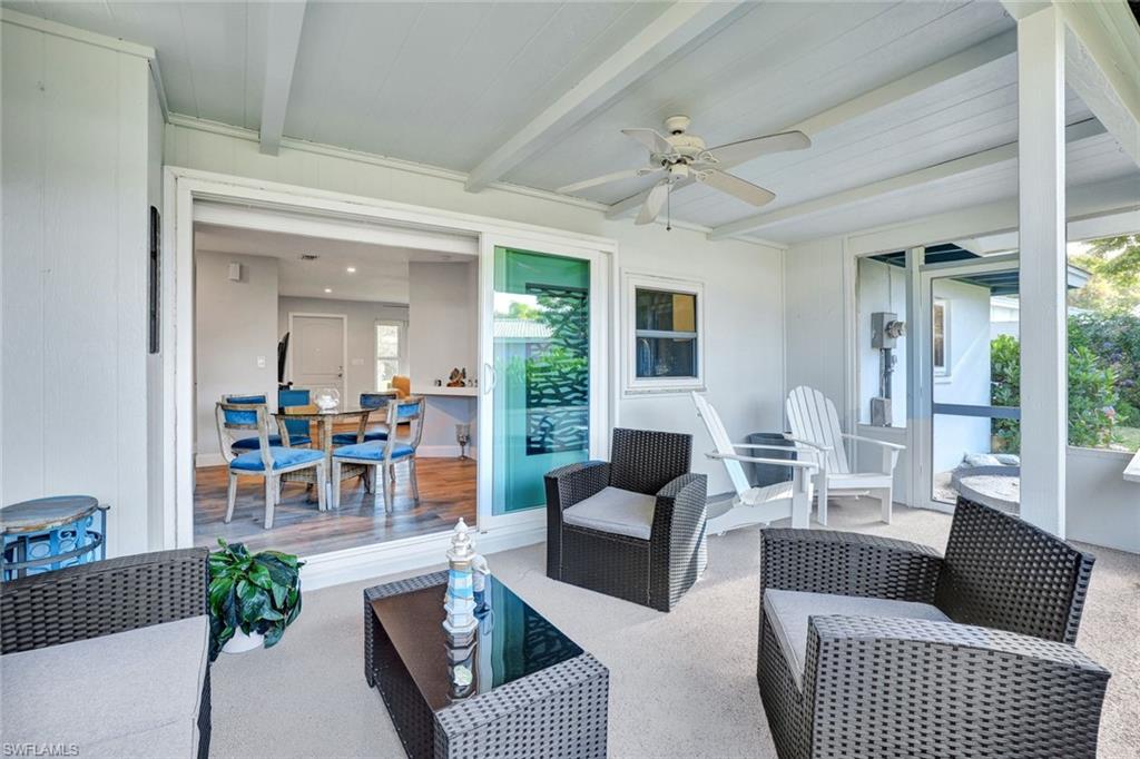 54 Hilo Court, Unit 54 Naples, FL 34112 - Photo 14 of 17 Expand patio featuring hurricane impact sliders.