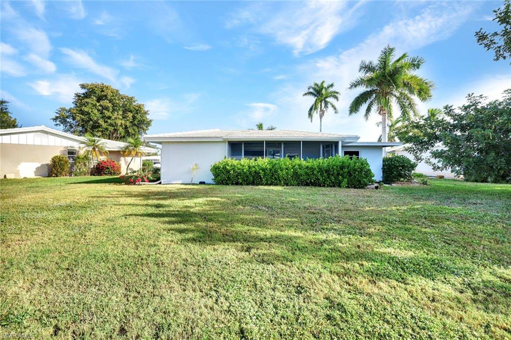 54 Hilo Court, Unit 54 Naples, FL 34112 - Photo 16 of 17 Oversized back yard featuring a firepit