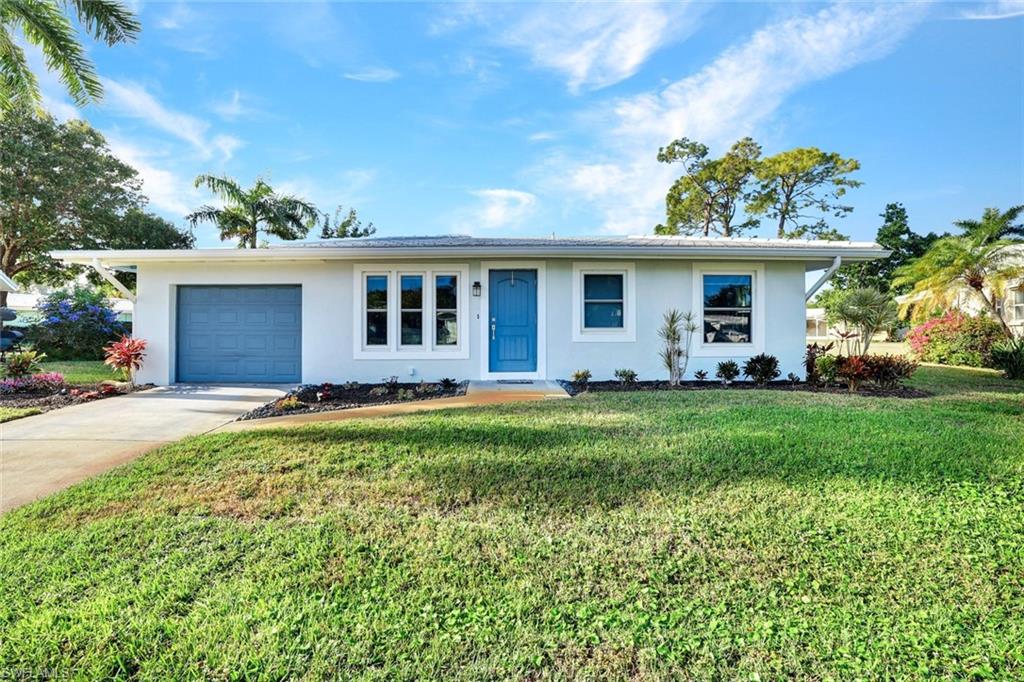 54 Hilo Court, Unit 54 Naples, FL 34112 - Photo 17 of 17 Single-family design featuring a new roof, gutters, impact windows and freshly painted.