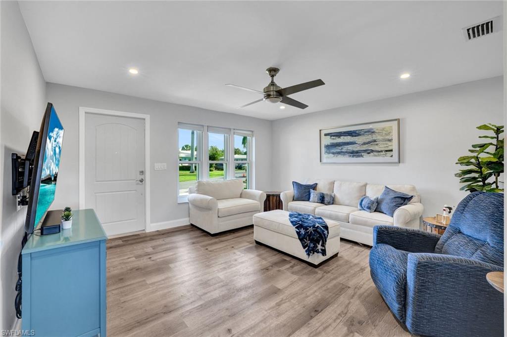 54 Hilo Court, Unit 54 Naples, FL 34112 - Photo 2 of 17 Fully renovated Living room featuring new recessed lighting, flooring and fixtures