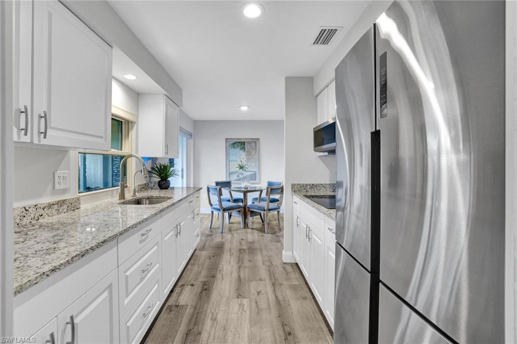 54 Hilo Court, Unit 54 Naples, FL 34112 - Photo 4 of 17 Renovated Kitchen featuring all new appliances with stainless steel finishes, recessed lighting, white cabinets, and countertops