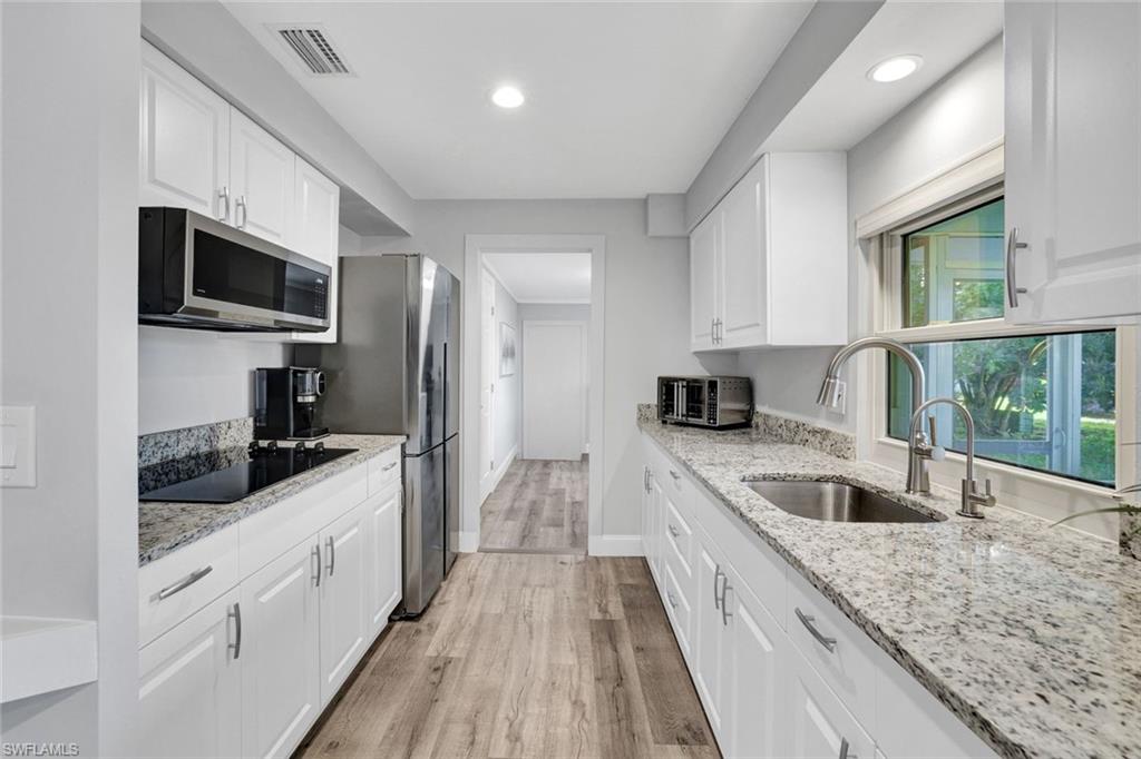 54 Hilo Court, Unit 54 Naples, FL 34112 - Photo 5 of 17 Renovated Kitchen featuring all new appliances with stainless steel finishes, recessed lighting, white cabinets, and countertops
