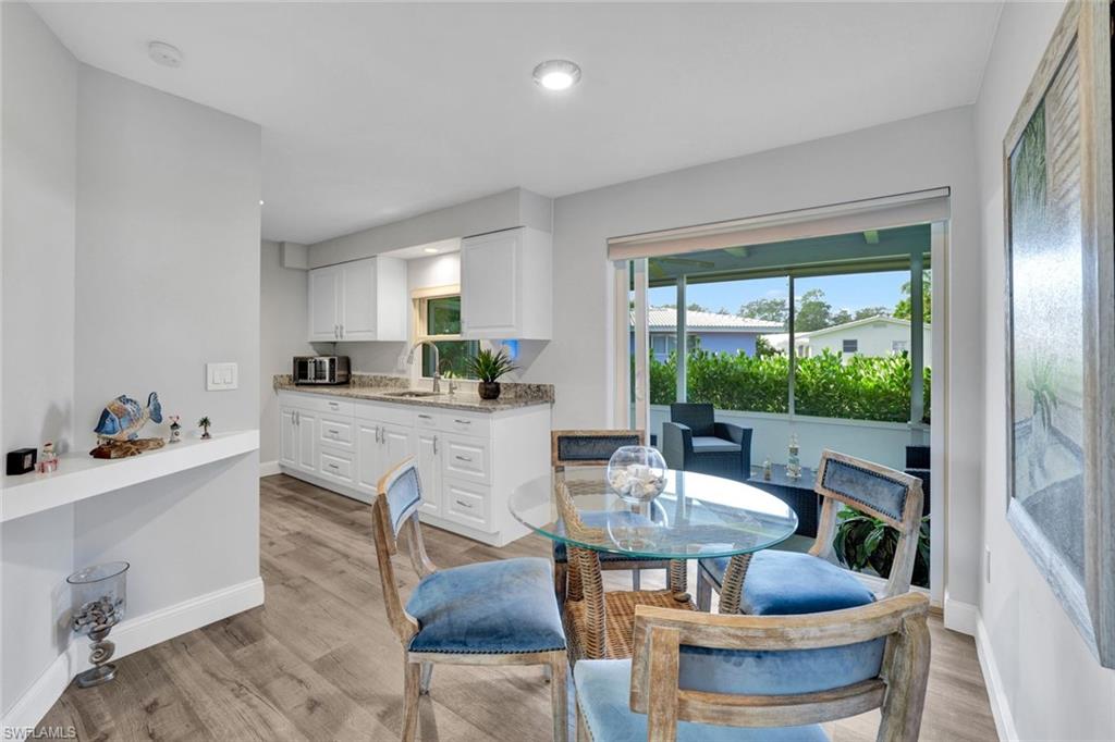 54 Hilo Court, Unit 54 Naples, FL 34112 - Photo 7 of 17 Breakfast nook off the expanded patio featuring new hurricane impact slider.