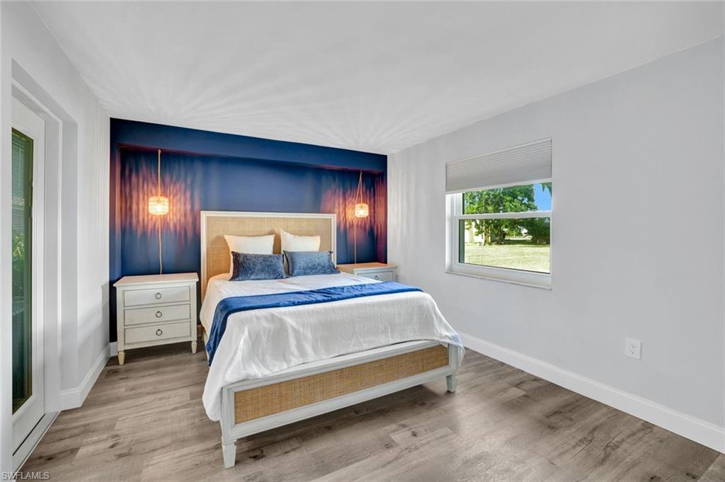 54 Hilo Court, Unit 54 Naples, FL 34112 - Photo 9 of 17 Primary Bedroom with new flooring, baseboard, and freshly painted.