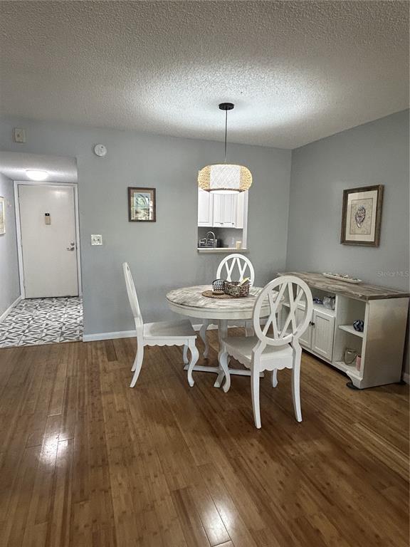 11485 Oakhurst Road, Unit 200307 Largo, FL 33774 - Photo 12 of 43 a view of a dining room with furniture and wooden floor