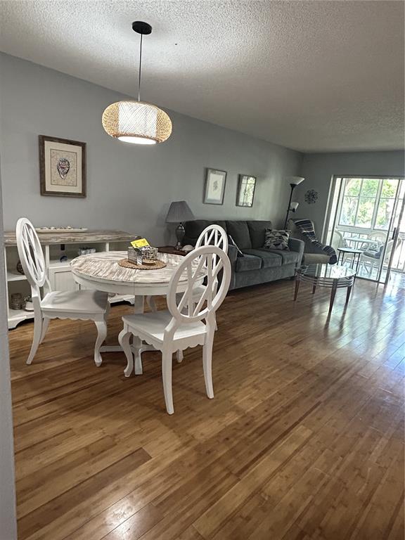 11485 Oakhurst Road, Unit 200307 Largo, FL 33774 - Photo 13 of 43 a view of a dining room with furniture wooden floor and chandelier