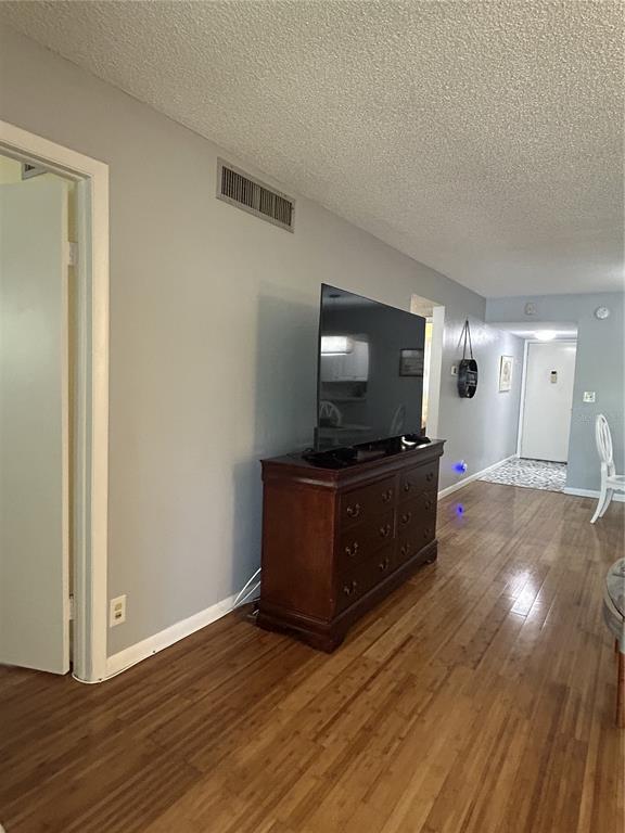 11485 Oakhurst Road, Unit 200307 Largo, FL 33774 - Photo 15 of 43 a living room with furniture and a flat screen tv